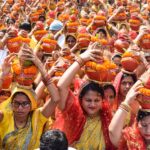 Women in vibrant attire participate in the Mangal Kalash Yatra, a traditional Indian ceremony.